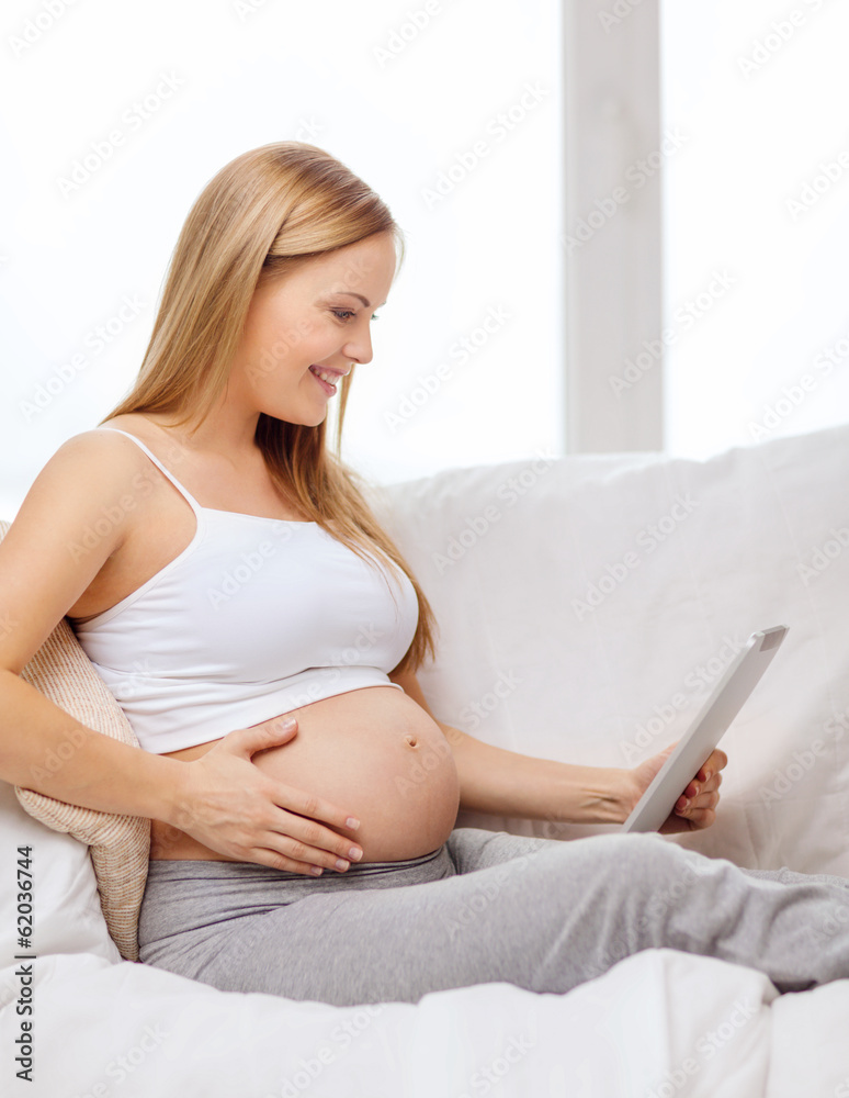 smiling pregnant woman with tablet pc computer smiling pregnant woman with tablet pc computer