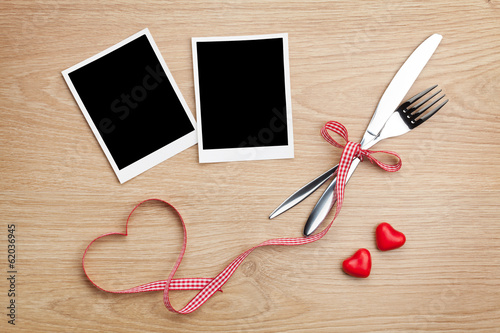 Blank photo frames with heart candy and silverware