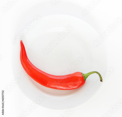 Red chili pepper isolated on a white plate