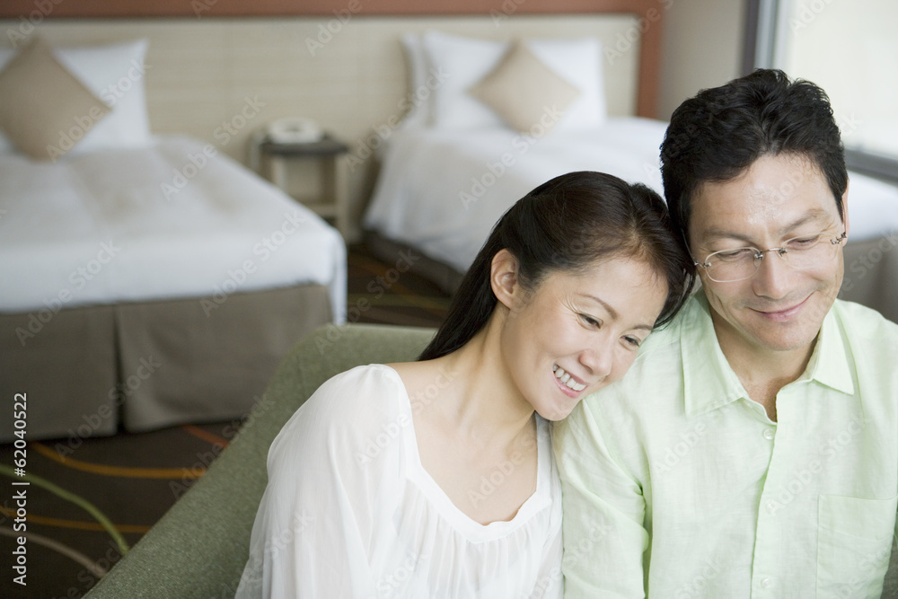 middle aged husband and wife nestling up in hotel room middle aged husband and wife nestling up in hotel room