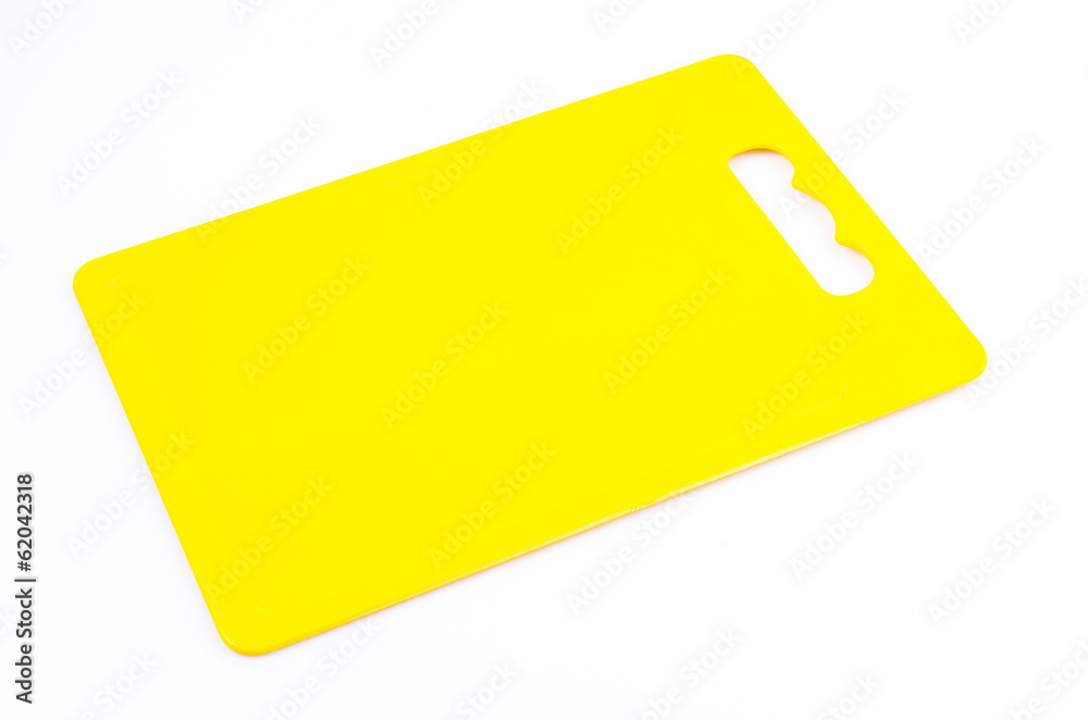Yellow plastic cutting board on isolated white background Yellow plastic cutting board on isolated white background