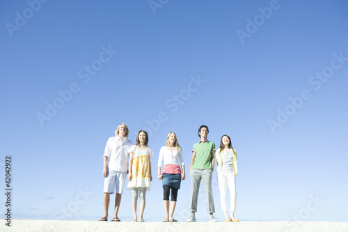 young people standing under blue sky