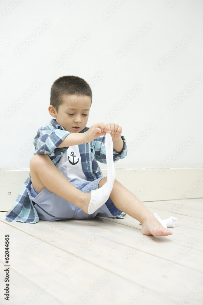 boy taking off socks Stock Photo | Adobe Stock