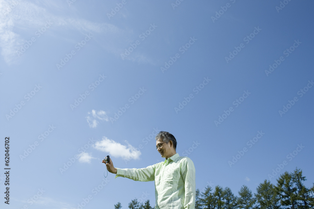senior man holding camera