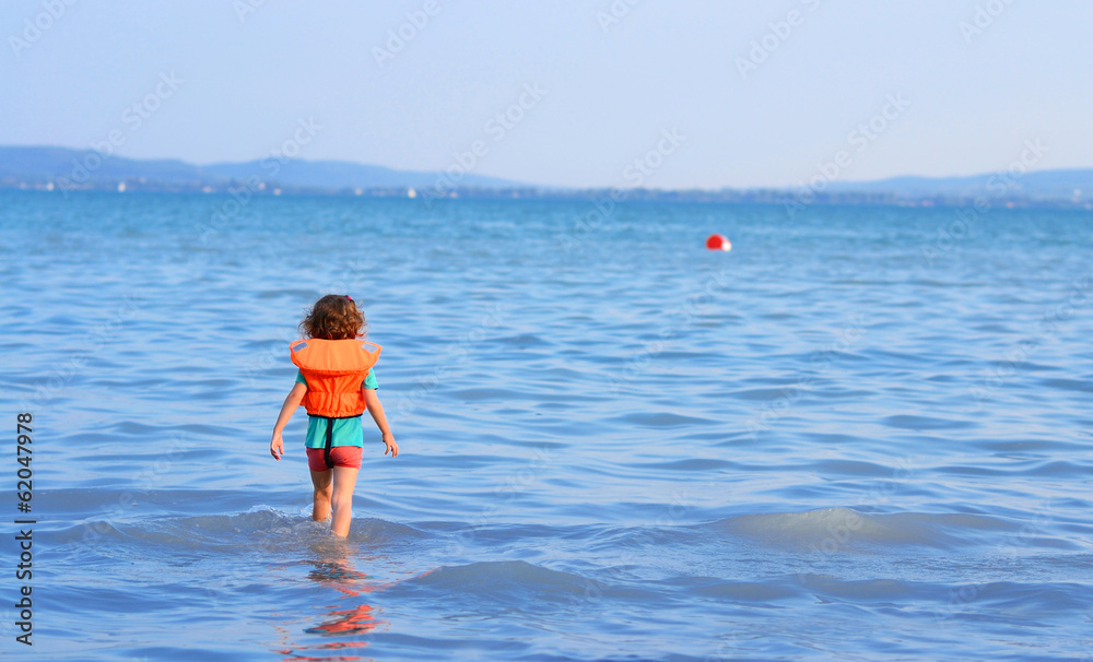 Little girl goes into the water