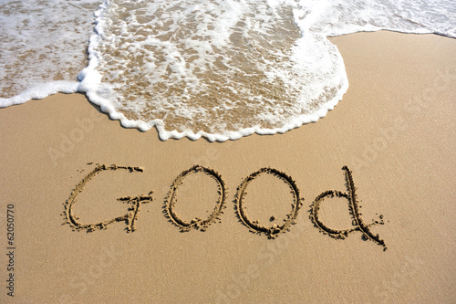 good word drawn on beach