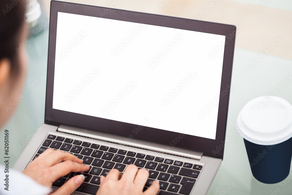 Fototapeta premium Businesswoman Working On Laptop With Disposable Cup