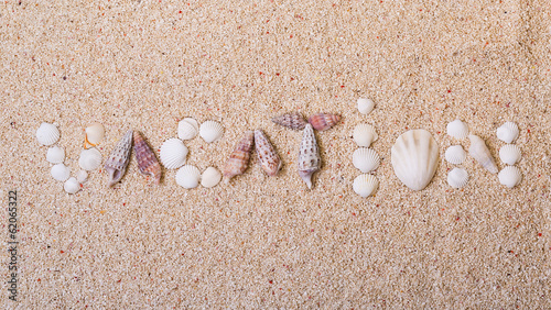 Title "vacation" from sea shells with coral sand
