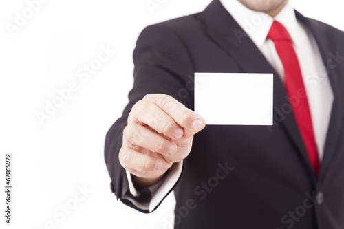 Man's hand showing business card - closeup shot on grey backgrou