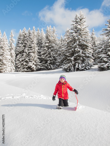 little girl in snow with sledge