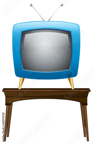A blue television above the wooden table