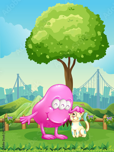 A pink monster and a monster cat near the tree