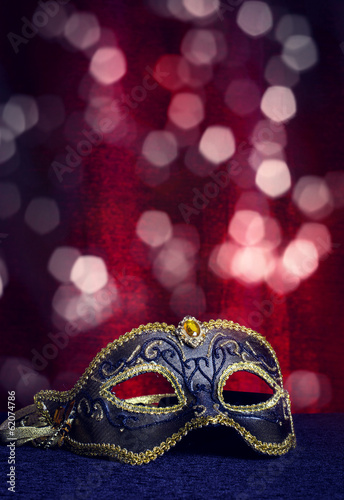 Carnival mask on a background of holiday lights.