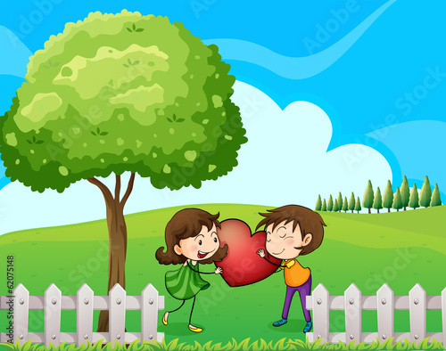A couple at the hilltop near the wooden fence