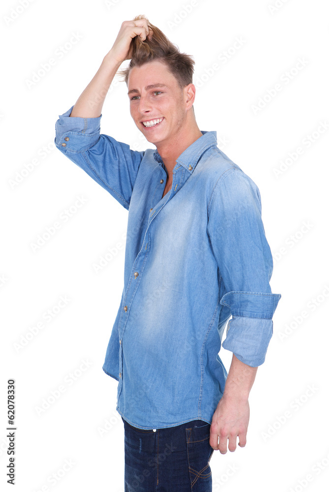 Man smiling with hand in hair Man smiling with hand in hair
