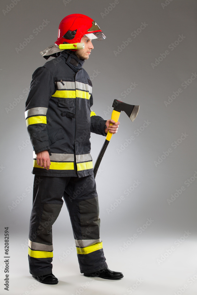 Fireman with axe, side view.