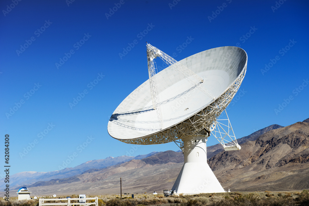 Satellite dishes in desert / clear blue sky