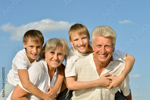 Happy family on sky background