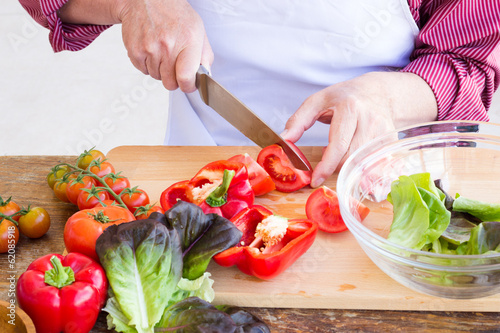 Man cutting vegetables for healthy salad photo