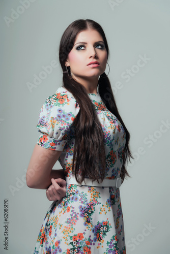 Retro 70s fashion. Pretty brunette girl with long hair. Wearing