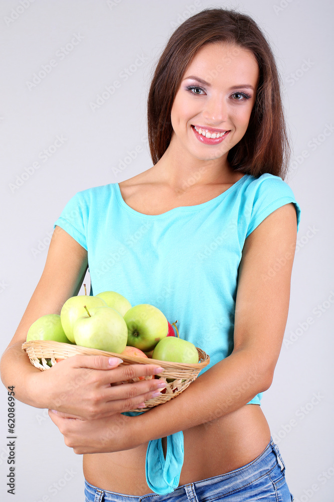 Beautiful young woman with basket of green apples Beautiful young woman with basket of green apples