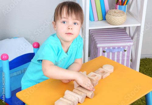 Little girl plays with cons...