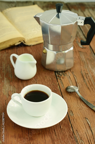Espresso, coffee pot and milk on rusted wooden background