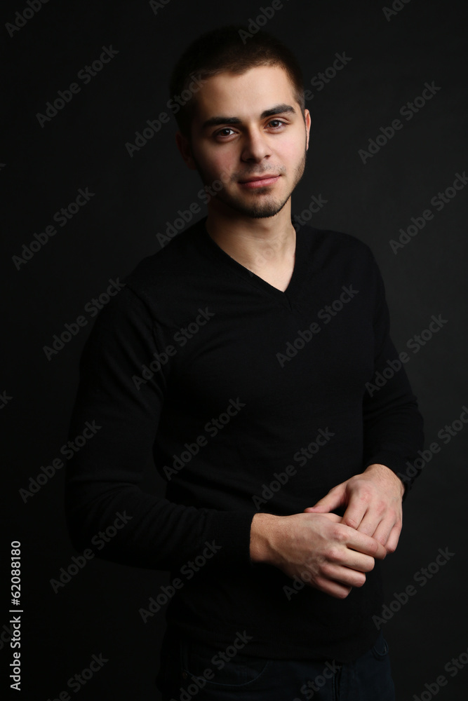 Handsome young man on dark background