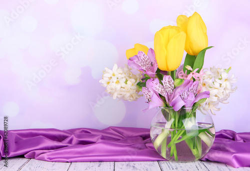 Fototapeta Naklejka Na Ścianę i Meble -  Flowers in vase on table on bright background