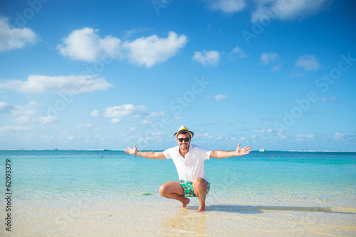 casual man welcoming you to the beach of mauritius