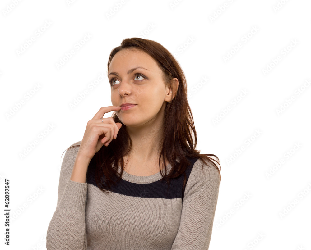 Thoughtful young woman standing daydreaming Thoughtful young woman standing daydreaming