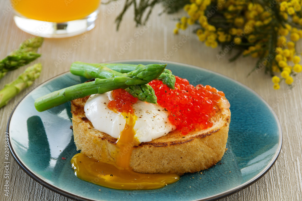 Fresh toast with poached egg, caviar and asparagus. Fresh toast with poached egg, caviar and asparagus.