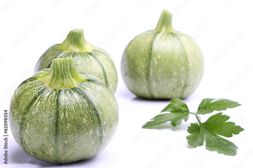 Round zucchini with parsley isolated on white Round zucchini with parsley isolated on white