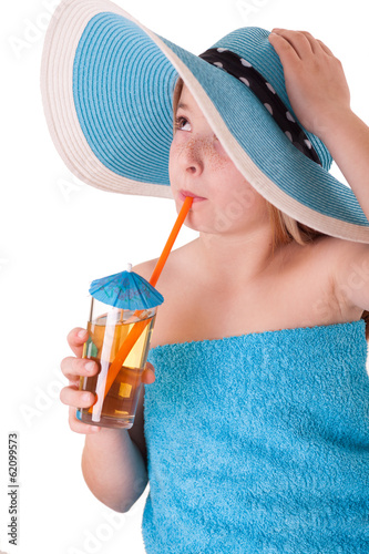 little girl in blue summer hat drinking juice
