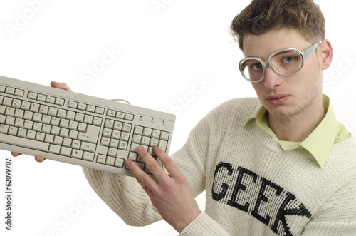 Geek playing video games with a keyboard, gamer wearing eyeglass