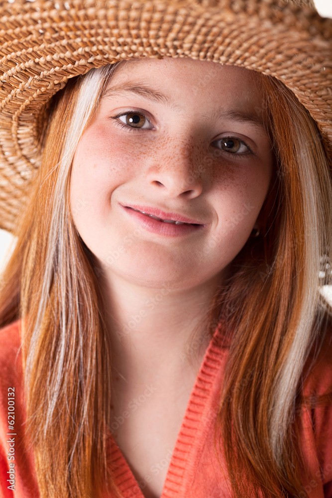 portrait of little red-haired girl with freckles and a straw hat portrait of little red-haired girl with freckles and a straw hat