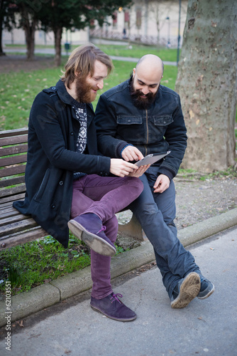 two bearded modern man working on tablet