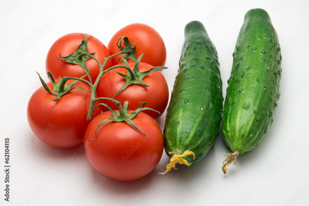 Five tomatoes and two cucumber on a white background Five tomatoes and two cucumber on a white background
