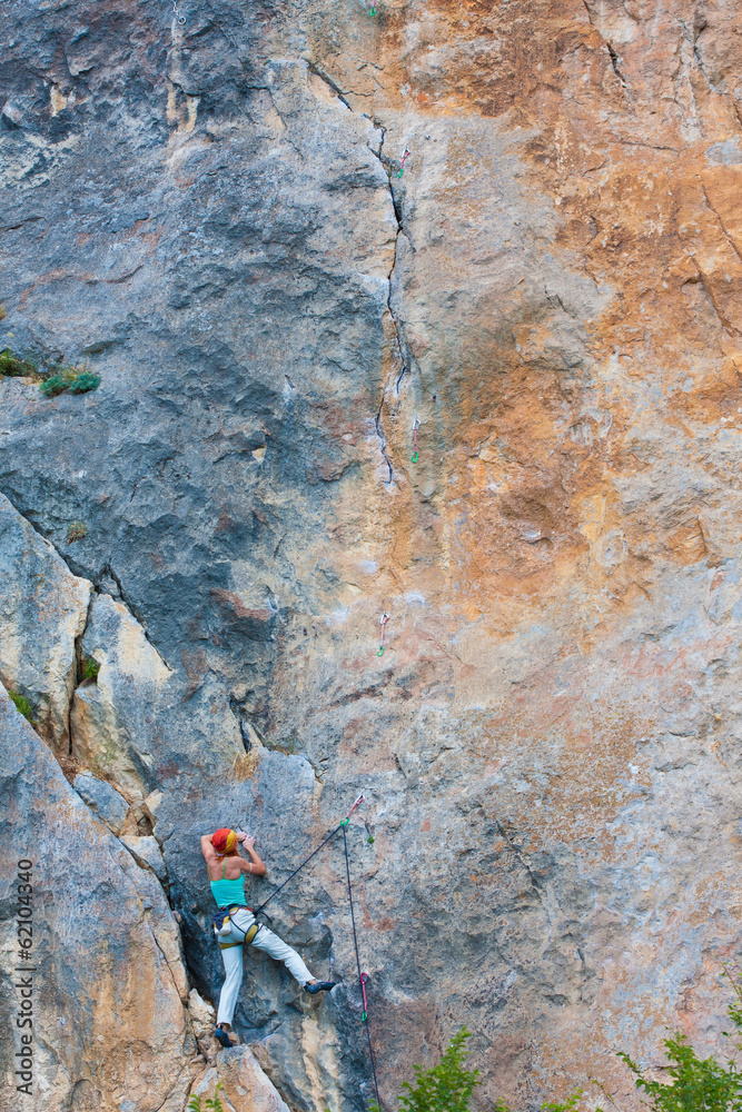 Fototapeta premium Female climber on a cliff