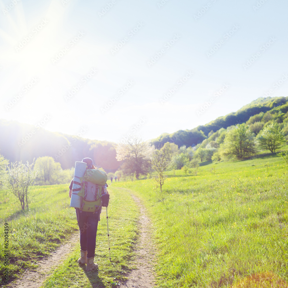Fototapeta premium Woman traveller on country road