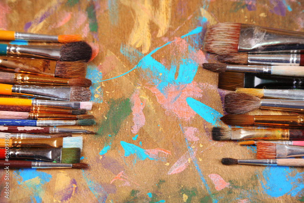 Obraz premium Brushes on multicolor wooden background