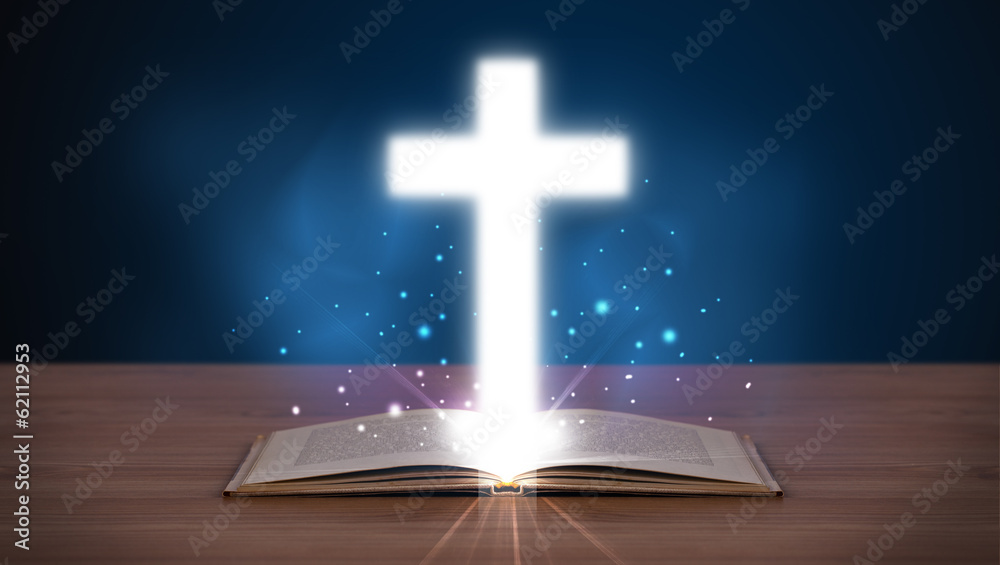 Open holy bible with glowing cross in the middle Open holy bible with glowing cross in the middle