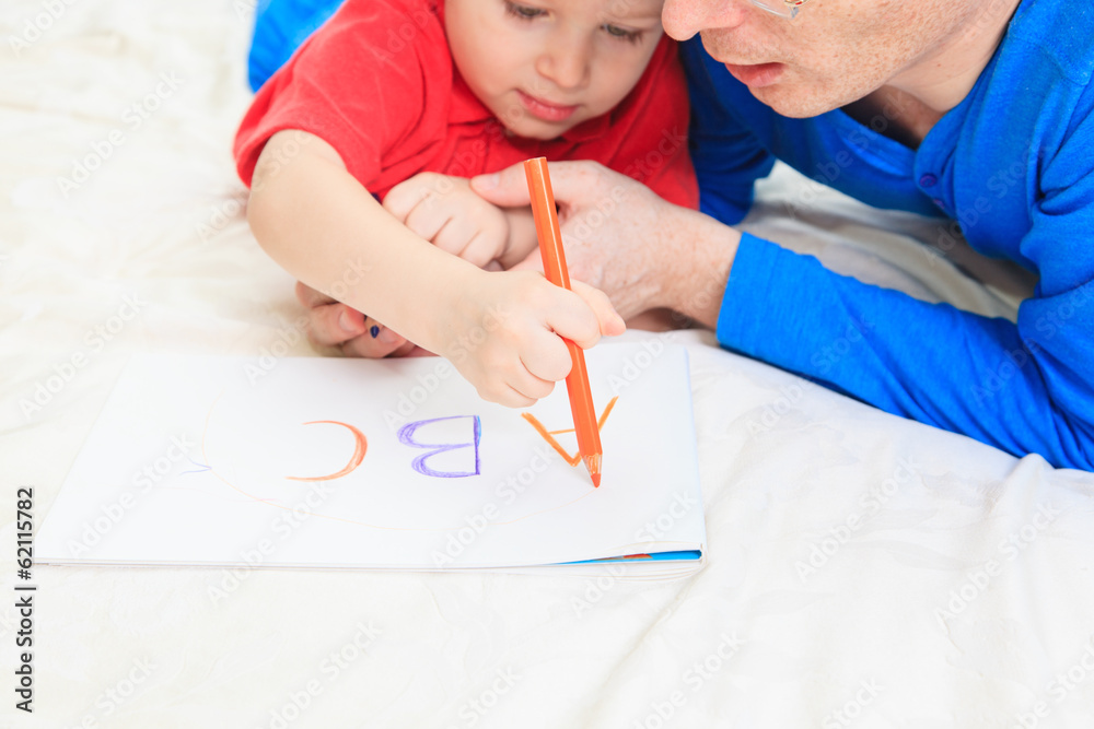 hands of father and child writing letters hands of father and child writing letters