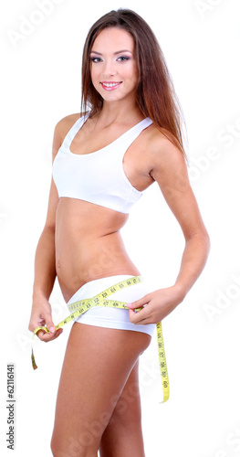 Beautiful young woman measu...