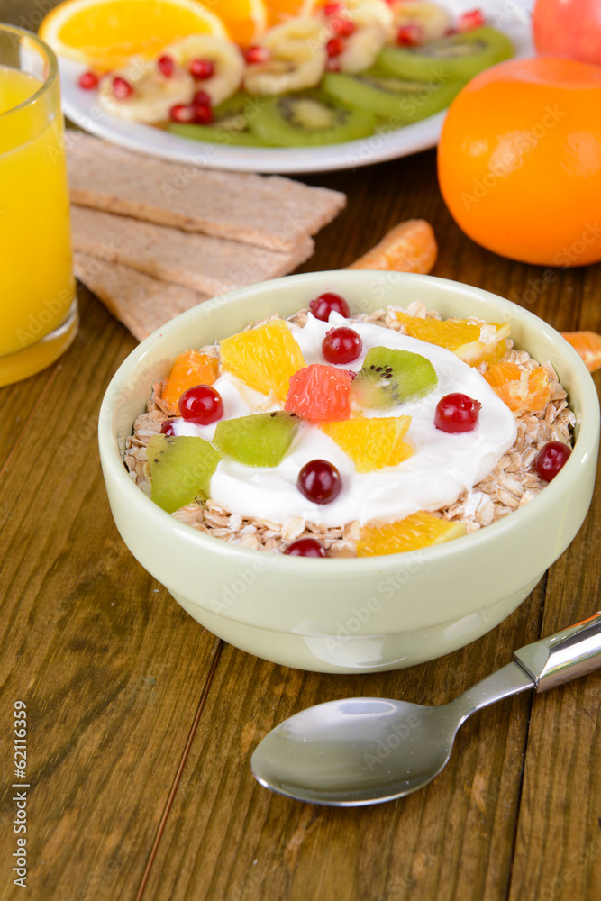 Delicious oatmeal with fruit in bowl on table close-up Delicious oatmeal with fruit in bowl on table close-up