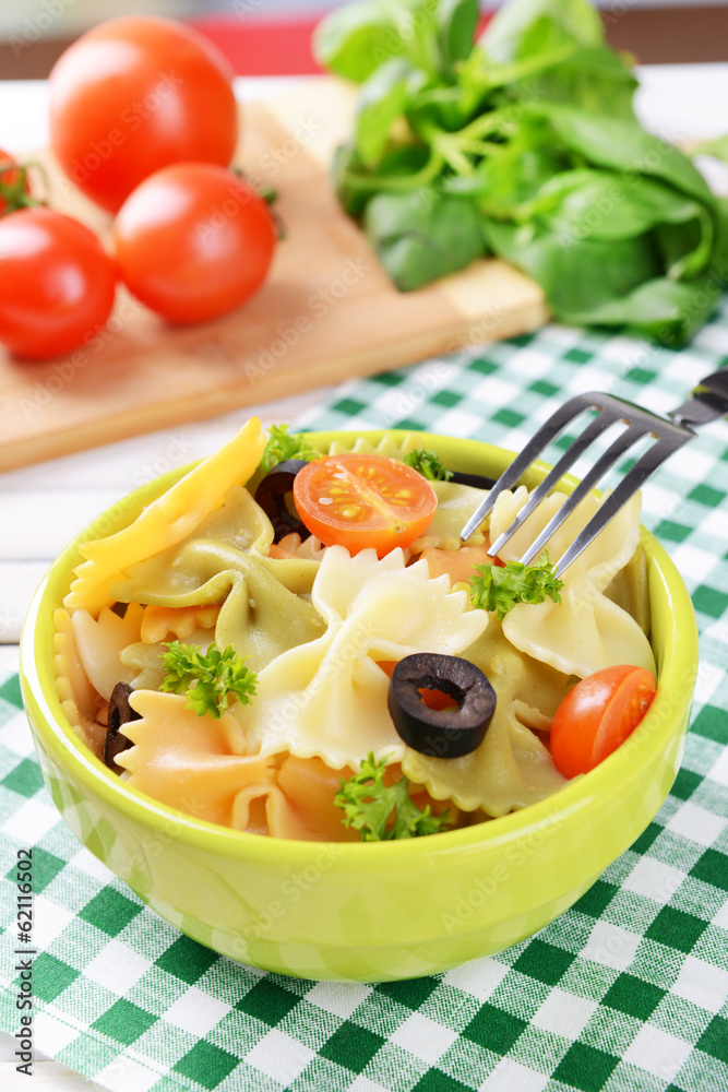 Delicious pasta with tomatoes on plate on table close-up Delicious pasta with tomatoes on plate on table close-up