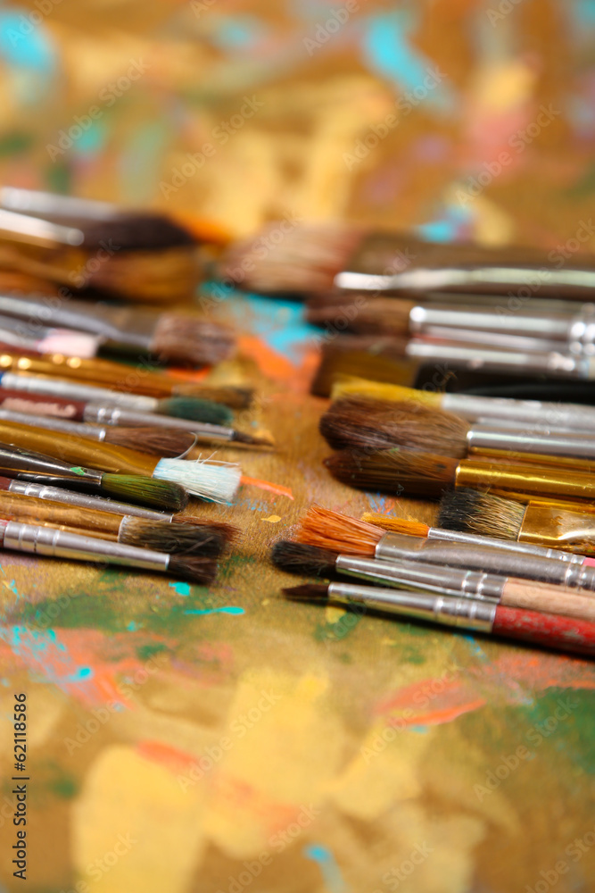 Fototapeta Brushes on multicolor wooden background