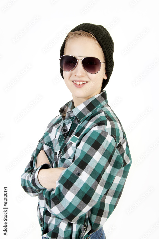 Smiling boy in sunglasses and a cap. Youth fashion. Smiling boy in sunglasses and a cap. Youth fashion.