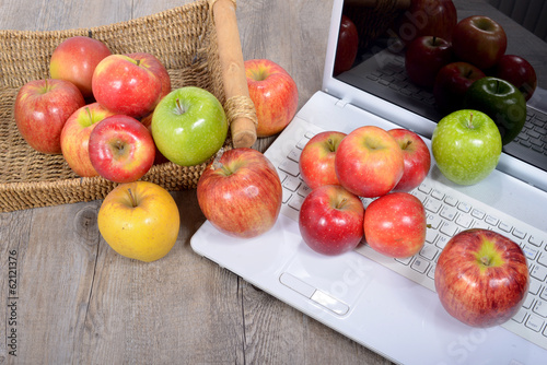 Fototapeta Naklejka Na Ścianę i Meble -  apples fell on the keyboard of a computer