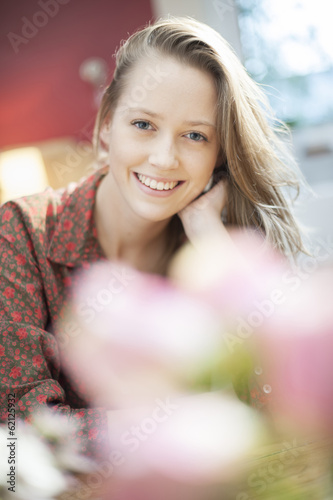 portrait closeup of a beautiful young woman with rose petals bl